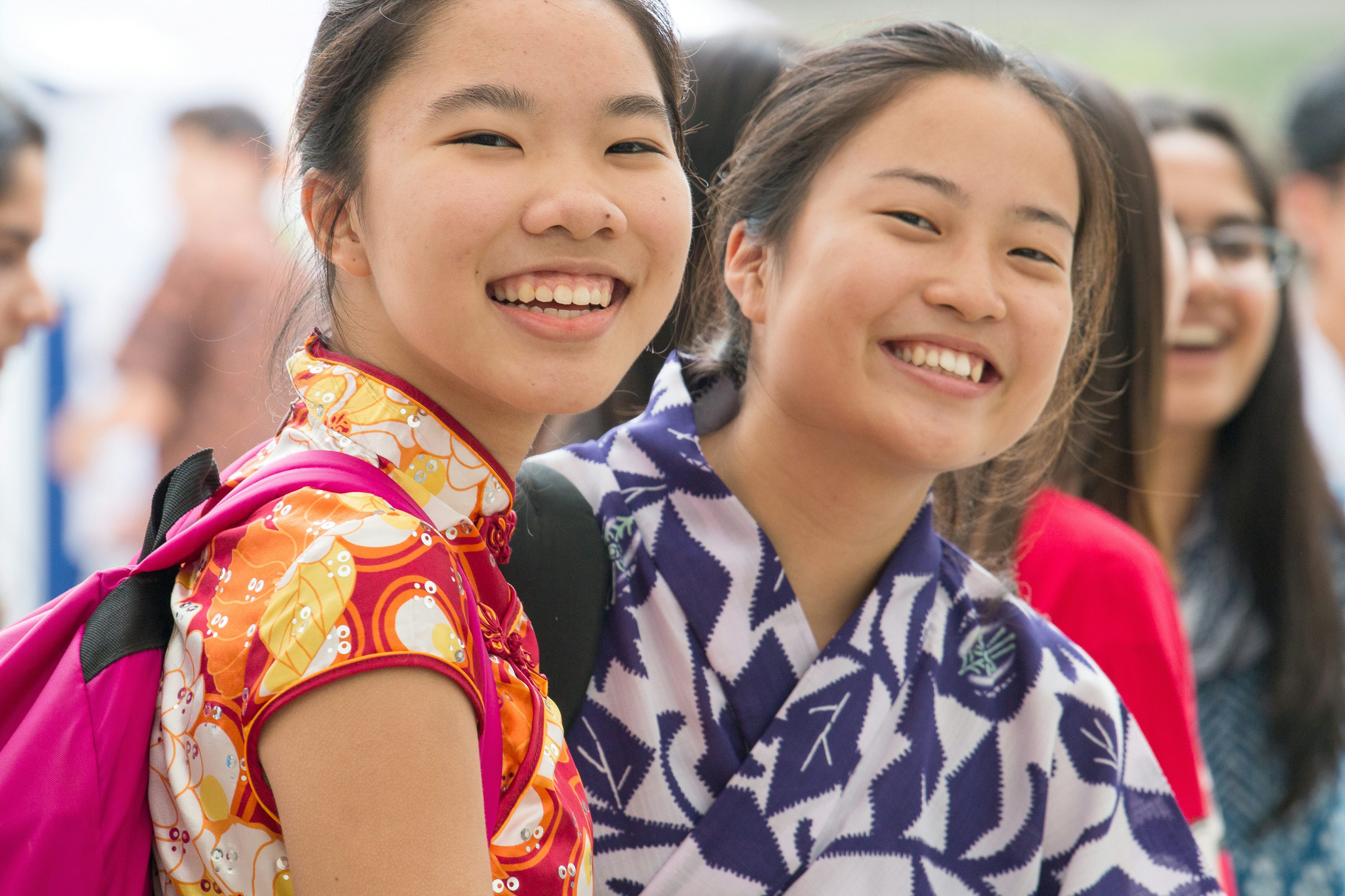 Two Asian looking girls smile to the camera